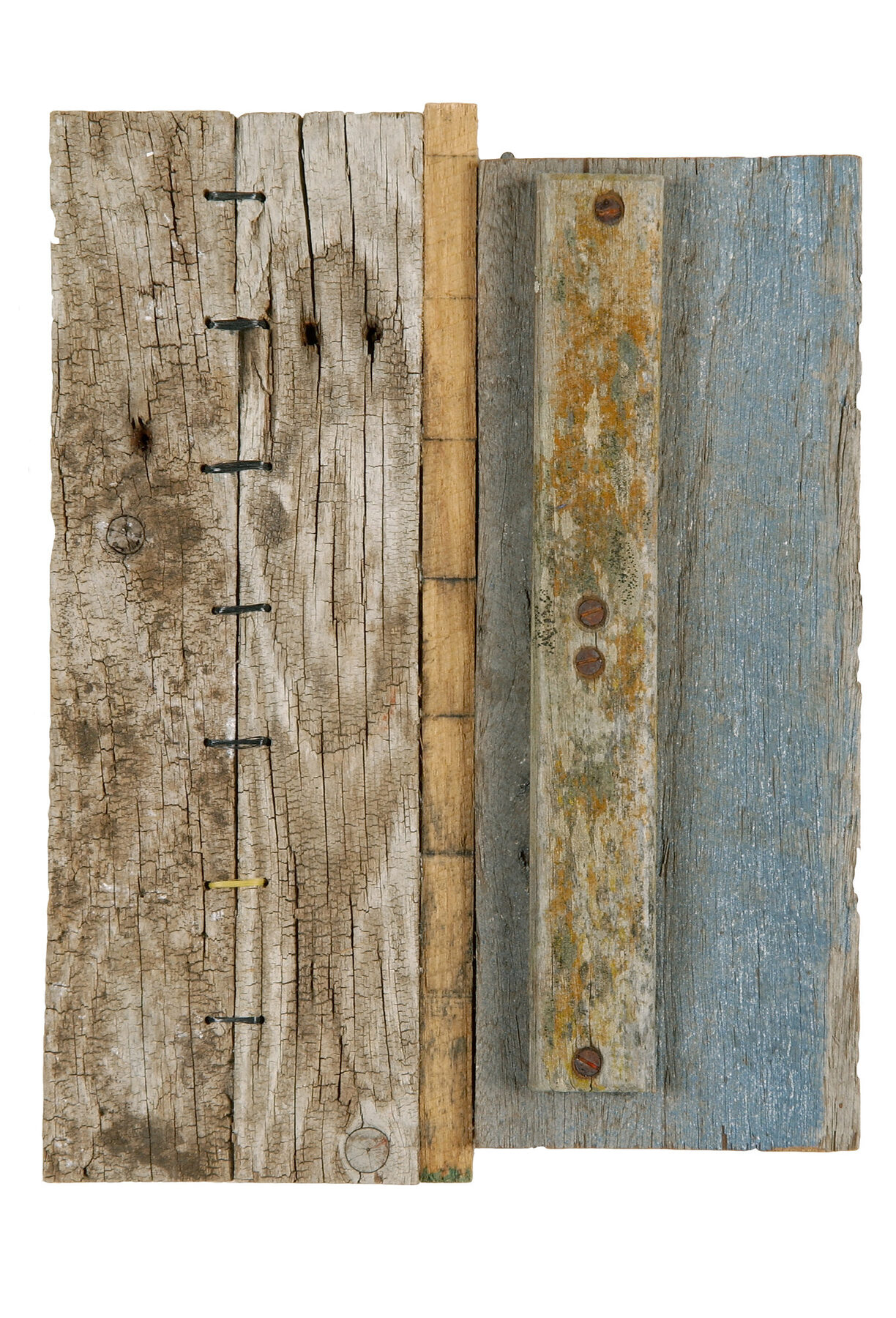 Two pale timber boards joined side by side, the right one stitched with a dark trailing leaf pattern and a line of pink thread.