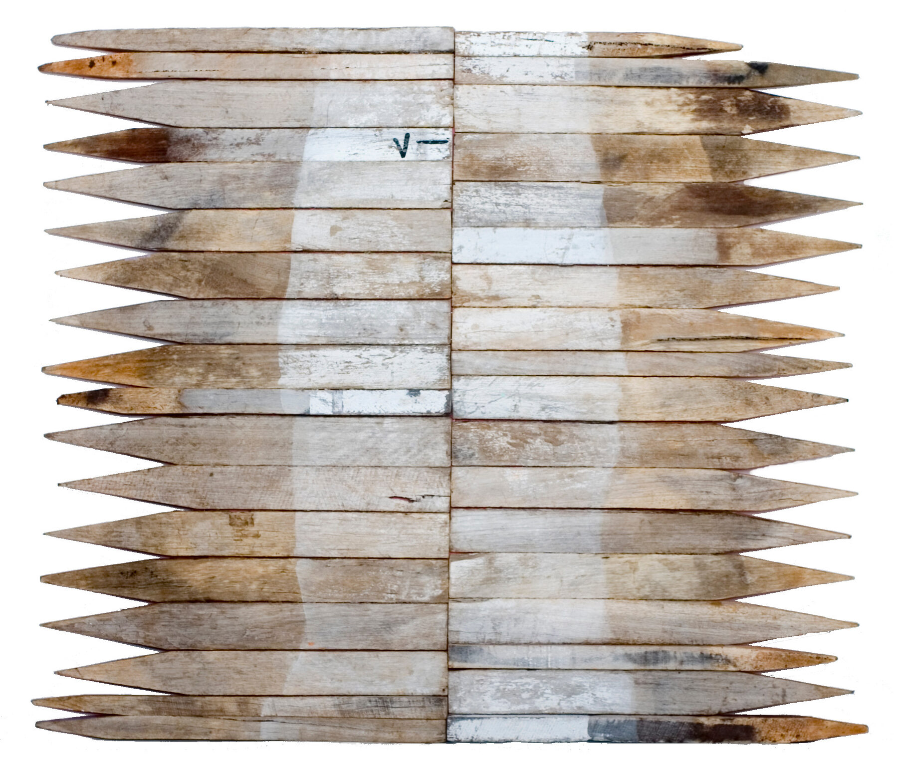 Rows of pointed white and weathered timber field pegs laid horizontally and stacked, tips outward, forming a pair of feathered wings.